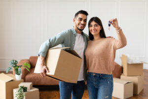 happy couple showing keys of their apartment